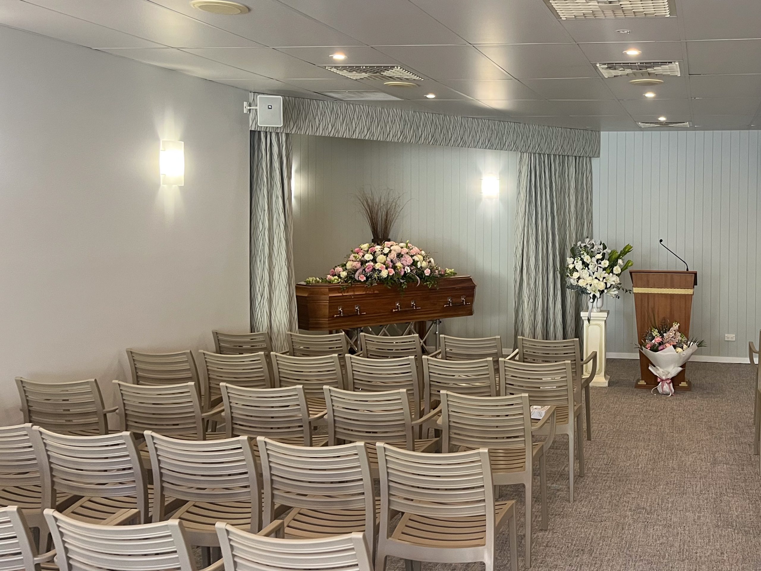 Refurbished Burleigh Heads Chapel with Coffin, floral display and beige chairs